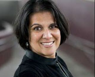 Female with dark hair smiling